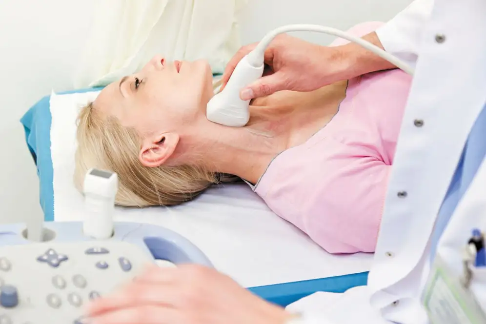 This is an image of a woman receiving a Carotid Ultrasound.