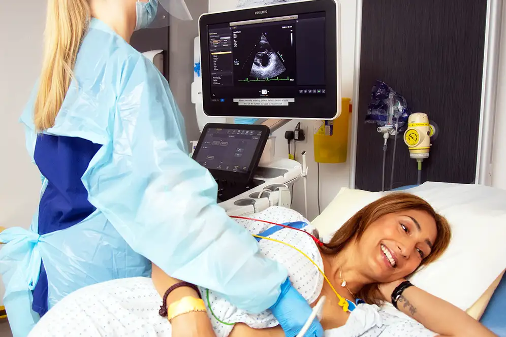 This is an image of a woman having an echocardiogram done.